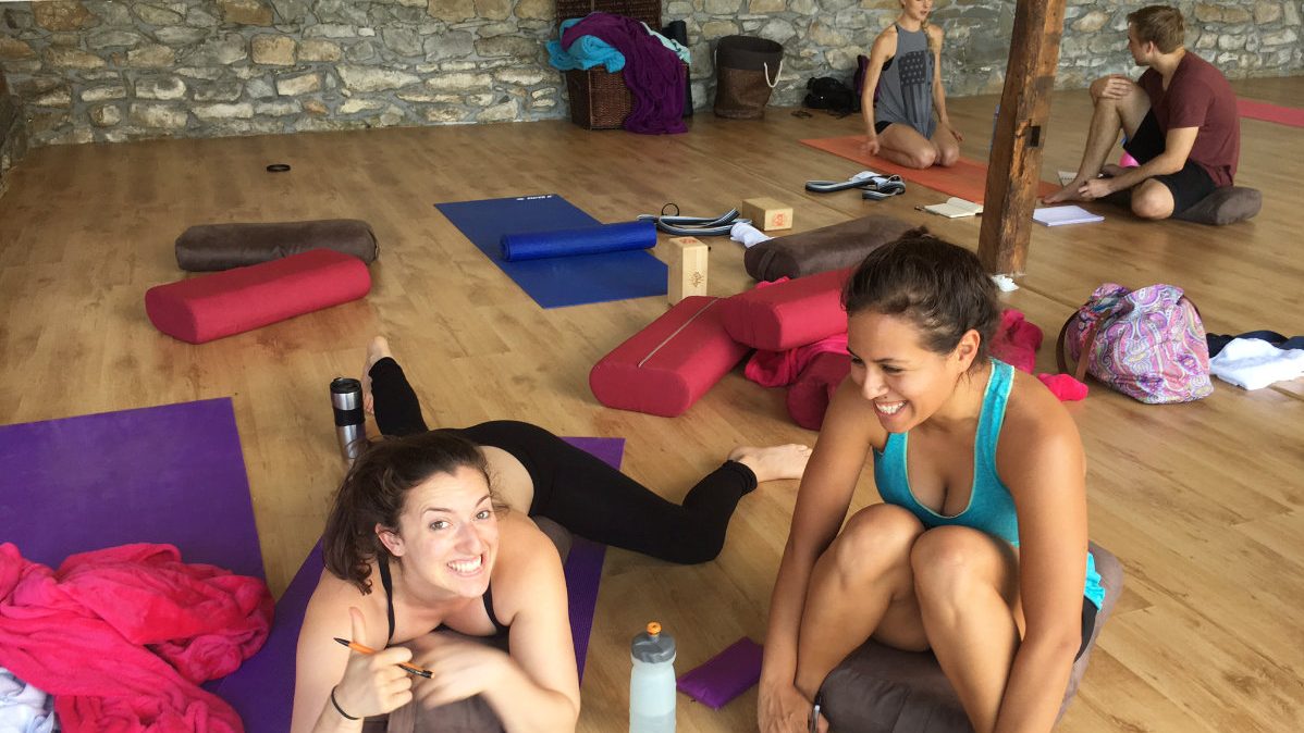 Two yoga trainees smiling